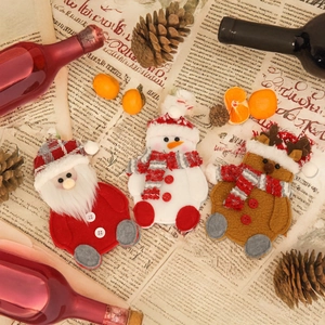 Christmas Santa Snowman Reindeer cutlery set on vintage newspaper with pine cones