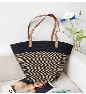Detail of contrast cotton rope tote bag with leather straps and reinforced gold rivets