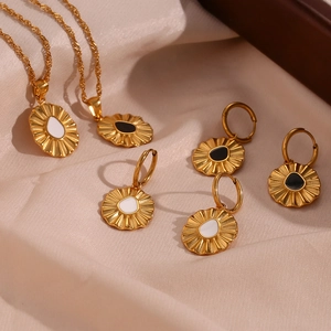Golden wave chain necklaces and earrings set with sunflower enamel charms on pink silk