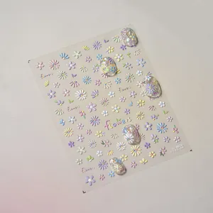 Detailed macro view of 5D embossed colorful daisy flower nail art stickers and decals