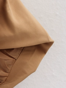 Detailed close-up of khaki woven fabric showing premium twill texture on a flight jacket