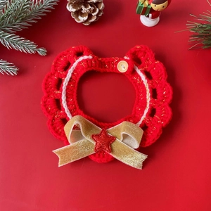 Handcrafted red knit pet collar with a gold glitter bow and festive Christmas star detail