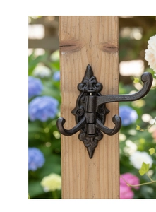 Detail of vintage cast iron triple swivel wall hook with matte finish for home decor