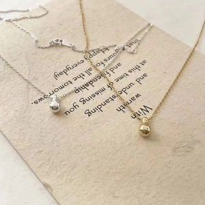 Detail showing gold and silver S925 sterling silver ball pendant necklaces with hallmark