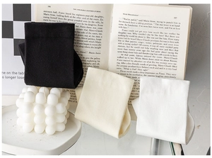 Detailed display of white, beige, and black cotton mid-tube socks in a cozy setting