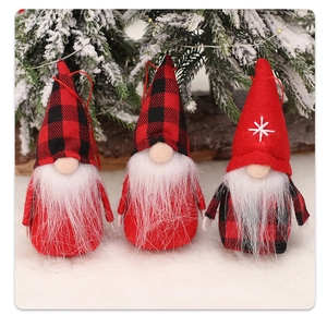 Three plush Christmas gnomes with red hats and star embroidery on a snowy background