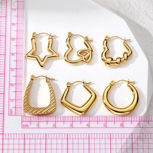 Set of 6 gold geometric earrings including heart and star shapes with measurement scale