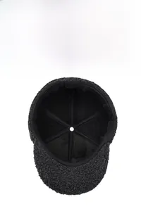 Detail of dark grey textured wool lining and inner stitching of the baseball cap for men