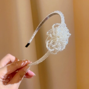 Detail of beaded headband featuring faux pearl flower clusters and non-slip black tips