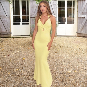 Close-up of yellow halter maxi dress featuring chest cut-out and metallic ring detail