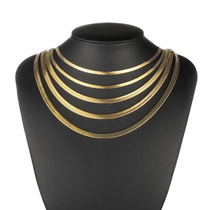 Flat snake bone chain necklace in gold-tone titanium steel shown on a black bust model