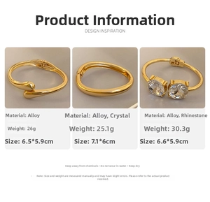 Detailed view of three gold-tone alloy bangles with crystal inlay and weight specifications