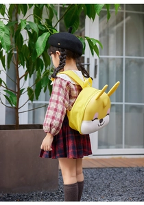 Outdoor side view of yellow 3D rabbit cartoon backpack for preschool children on model
