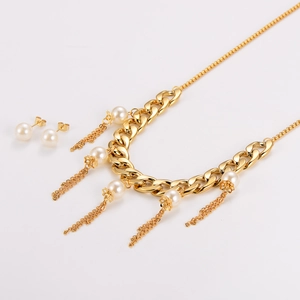 Detailed shot of golden stainless steel chain necklace with pearls and matching earrings