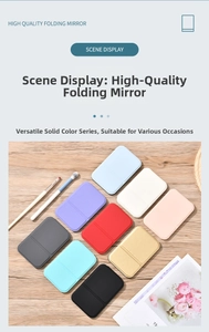Flat lay of portable folding makeup mirrors in ten solid colors on a wooden surface
