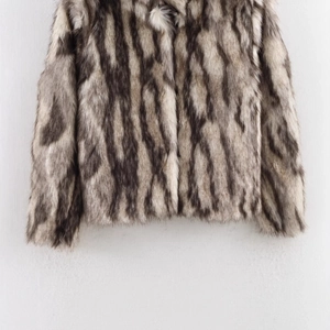 Chic faux fur coat featuring a black, grey and white animal pattern texture