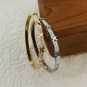 Elegant gold and silver stainless steel bangles with diamond inlay and X-shaped accent