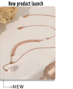 Close-up of pearl wheat pendant and S925 engraved clasp on 18k gold necklace