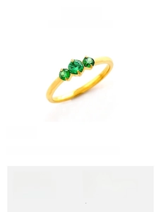 Detail of a 2mm gold-plated titanium steel ring featuring three green zircon stones