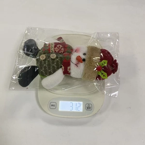 Weight measurement of a plush Christmas snowman ornament on a digital scale