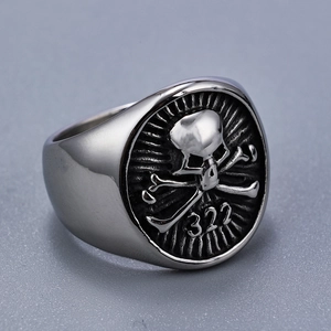 Macro shot of punk style stainless steel skull ring with embossed number 322