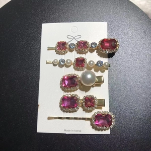 Detailed set of five vintage gold hair clips with pink and blue rhinestones and pearls