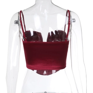 Macro view of burgundy velvet corset top back with adjustable straps and metal buckles
