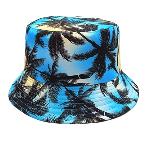 Detail of tropical palm tree print on blue and yellow gradient reversible bucket hat