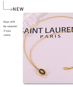 Detail of 18k gold plated stainless steel necklace with blue shell star oval pendant