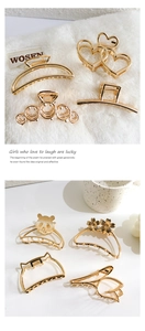 Collection of golden metal hair claws in heart and bear shapes on elegant background