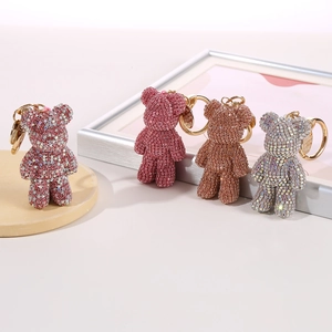 Sparkly rhinestone bear keychains in pink, purple, bronze, and silver on display