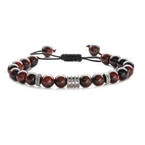 Detail of red-brown tiger eye stone beads with silver metal carvings on braided cord
