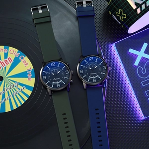 Detail of quartz sport watches with silicone bands on a neon-lit vinyl record background