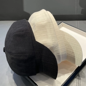 Detail view of black and white striped octagonal hats with jacquard texture on display