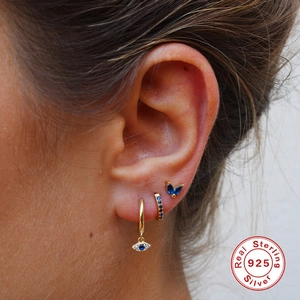 S925 sterling silver evil eye earring set with blue crystals in gold finish worn by model