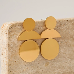 Modern geometric 316 stainless steel earrings in golden finish on stone display