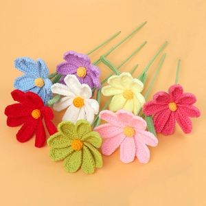 Detailed close-up of handmade crochet flowers in various vibrant yarn colors