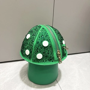 Macro detail of green mushroom-shaped rhinestone bag with white polka dots and gold zipper