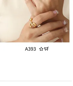 Detail of adjustable gold snake curve open ring with spherical ends on fingers