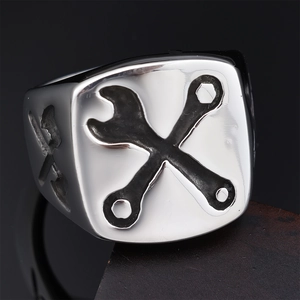 Macro view of industrial silver square ring featuring engraved cross wrench pattern