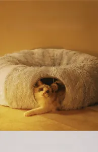 Detail of plush grey cat tunnel bed with a cat peeking through the cozy opening