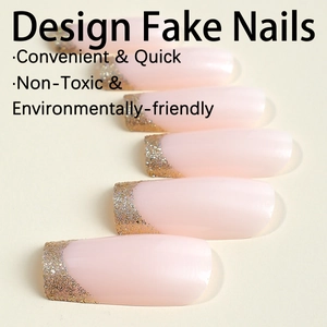 Pink press-on ballerina nails with gold glitter French tip design and glossy finish