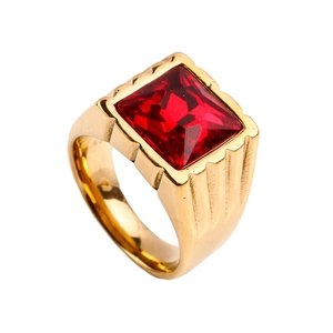 Detailed macro shot of vintage gold titanium steel ring featuring a square red gemstone