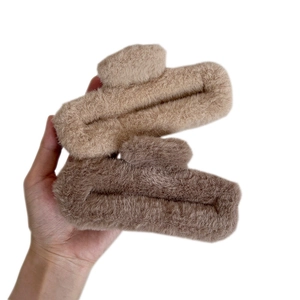 Large plush claw clips in beige and brown faux fur for women's winter hair styling