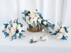 Detailed set of cream wedding roses with navy berries and hemp rope handle wraps
