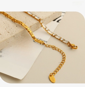 Detailed close-up of a gold stainless steel necklace featuring rectangular zircon stones