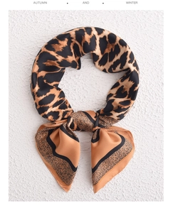 Close-up of leopard print satin square scarf with a knot detail on white texture