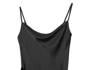 Detail of adjustable thin straps and cowl neckline on a black satin slip dress