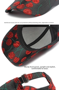 Detail view of cherry pattern jacquard fabric and adjustable metal buckle on baseball cap