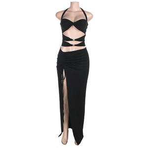Detail of black halter crop top with gold metal buckle and side slit drawstring skirt